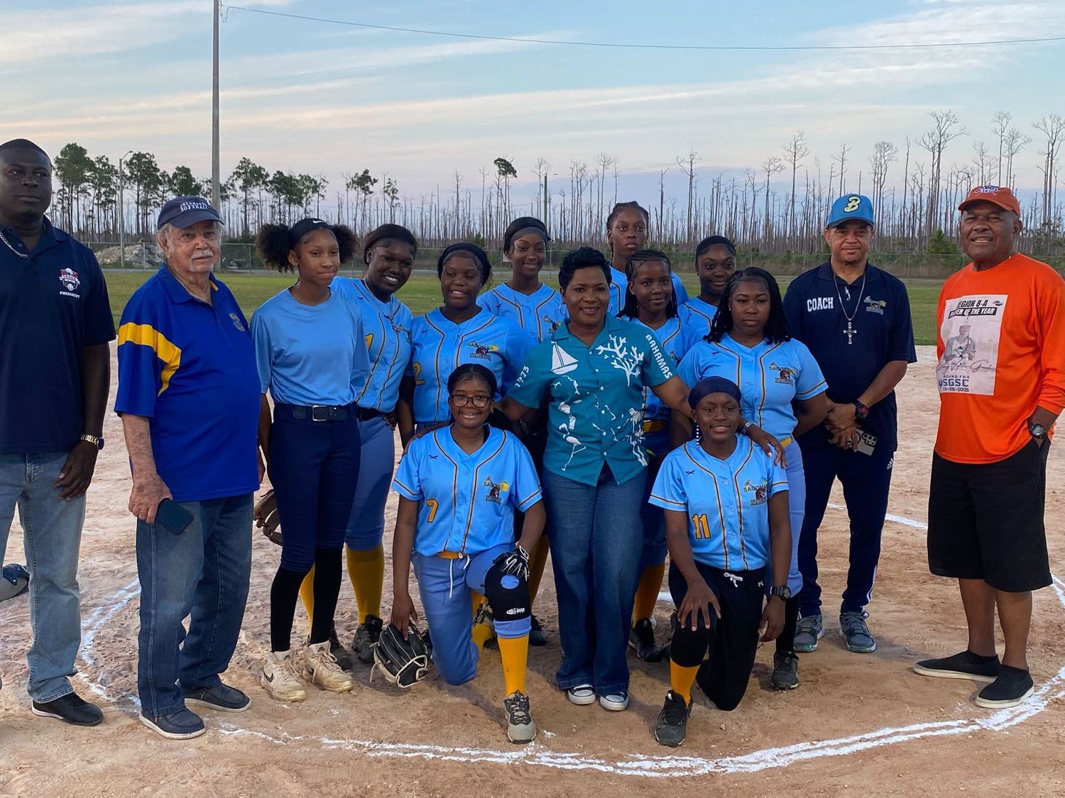 Sagoma-sponsored girls&rsquo; softball team photographed on the diamond in Freeport, Grand Bahama, with their coaches